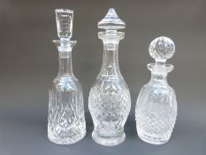 Three Waterford Crystal Colleen pattern decanters, largest 32cm tall.
