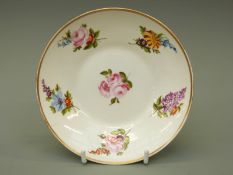 An 18thC Swansea porcelain saucer decorated with roses, lilac, auriculas etc, 14.