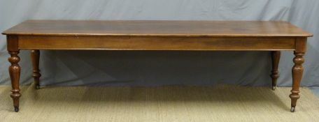 A large 19thC oak table, raised on turned legs and brass castors,