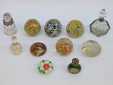Eleven glass paperweights and cut glass scent bottles, some silver mounted.