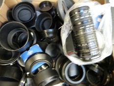 A box of camera lens caps, filters etc.