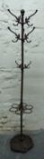 A cast iron hat/stick stand with trefoil drip tray base,