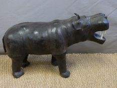 A small Liberty style leather footrest in the form of a hippo,