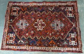 A Persian Shiraz wool rug with three guls,