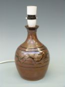 A Winchcombe studio pottery lamp base with trailed design,