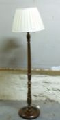 An oak standard lamp with shade,