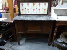An oak washstand with marble top and tile back,