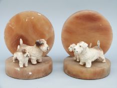 A pair of Art Deco onyx bookends with cold painted bronze Sealyham terriers with puppies, H11.
