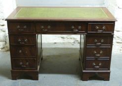 A leather inset twin pedestal desk,