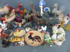 A quantity of cockerel figures, some ceramic,