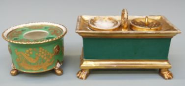 Two 19thC porcelain inkwells, both with green ground and raised on lion's paw feet,