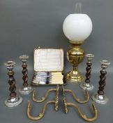 An oil lamp with glass shade together with four candle sticks of barley twist design,