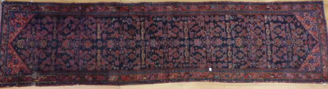 An Afghan runner with blue and pink decoration,