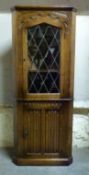 An oak glazed corner cupboard,