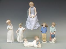 Six Nao figures including a girl with kitten, schoolgirl, schoolboy etc,