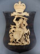 A late 18th/19thC carved ivory figure of St George and the dragon mounted on a wooden plaque,