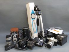 A quantity of cameras including Olympus OM-1 with 1:1.8 50mm lens, Super Paragon 1:2.