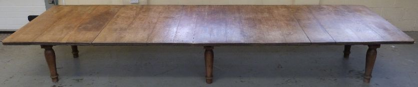 An exceptionally large 19thC dining/banqueting table, the oak top formed of approximately 14 leaves,