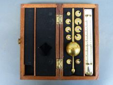 A brass hydrometer in fitted wooden case