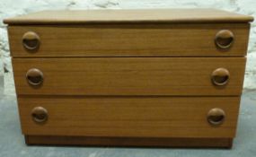 A retro G Plan style low chest of three drawers,