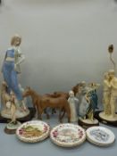 A large ceramic figure of a lady with a dog, continental figures, carved wooden horses,