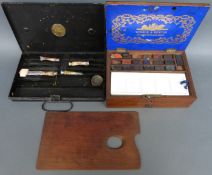 A vintage Winsor and Newton artist's box and a Winsor and Newton metal box with palette and paints