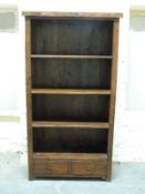 An Indonesian hardwood bookcase of three shelves over two drawers,