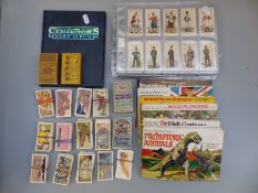 A collection of cigarette and trade cards including Turf British Aircraft, military themed,