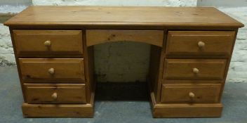 A pine dressing table with three drawers to either side,