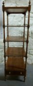 An elm five tier what-not with single drawer raised on turned legs,