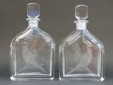 A pair of Orrefors glass decanters of flattened form with etched pheasant decoration,