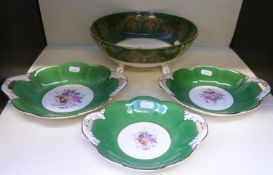 Four pieces of Coalport comprising bowl and three twin-handled dishes, one signed,