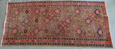 Persian wool rug, blue centre on pink ground with stylised floral design,
