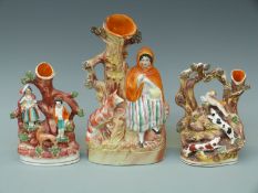 Three 19thC figural Staffordshire spill vases including hounds chasing a lamb and Red Riding Hood,