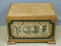 A wooden storage box or toy trunk with Simmons and Co decoration to front,