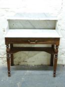 A 19thC marble top mahogany washstand with single drawer and gallery back,
