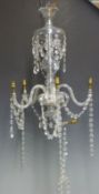 A five branch cut glass chandelier with multifaceted cut glass drops and swags, 60cm tall.