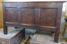 An 18thC oak three panel coffer with carved decoration of stylised acanthus,