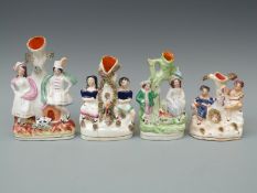 Four 19thC Staffordshire figural spill vases including sweethearts, children etc,