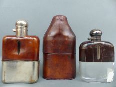 Three spirit flasks in leather cases
