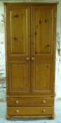 A pine wardrobe with two drawers,
