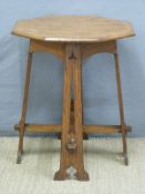 An Art Nouveau/ Arts and Crafts octagonal oak table with pierced legs and peg jointed stretcher,