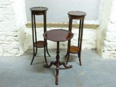 Two Edwardian inlaid jardiniere stands with undershelves,