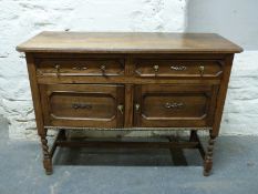 A small oak sideboard raised on barley twist legs,