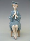 A Lladro figurine of a graduate,
