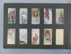A collection of cigarette cards in an album,