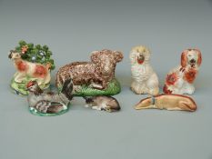 Seven mainly 19thC Staffordshire figures including a greyhound, ram, cow etc,