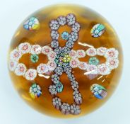 Clichy style patterned millefiori glass paperweight with four garlands of multi-coloured canes