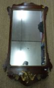 A 19thC mahogany wheatear mirror with gilded bird surmount, probably Regency,