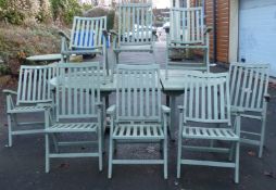 A teak garden set including oval extending table and eight reclining chairs, large parasol,